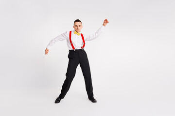 Handsome young gentleman dancing in vintage style on white background, showcasing energy and...