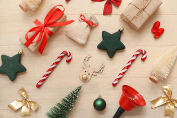 Gifts and Christmas symbols on wooden background