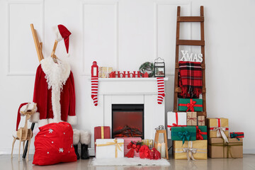 Interior of hall with Santa costume, fireplace and Christmas presents