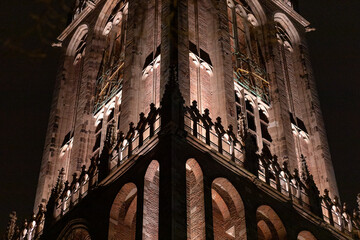 Architectural detail of renovated cathedral church tower of De Dom in Dutch diocese city lit up by...