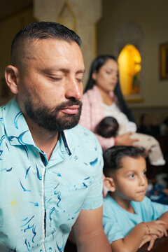 Catholic family praying in church