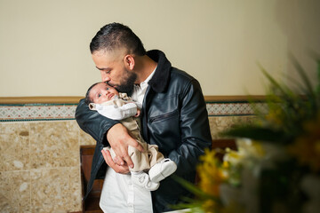 Man gives a tender kiss to a baby