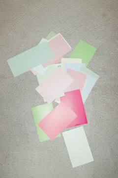 Colourful papers on a modern concrete background and direct flashlight