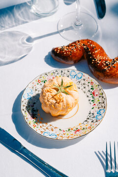 Elegant table setting with gourmet pastry and sesame bread twist