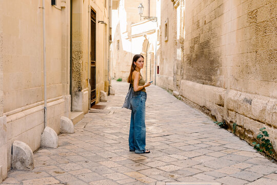Tourist walks in the alleys of the city of Lecce in Puglia, Italy