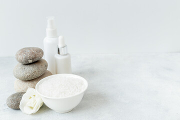 Spa set with white roses and blank bottles of skin care cosmetics