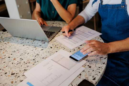 Business people analyzing financial documents at restaurant