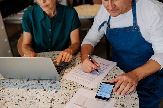 Two business owners doing finances at a coffee shop