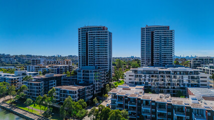 Fototapeta premium Panorama Aerial view above Rhodes with views to Meadowbank and Olympic park and Wentworth Point and Concord West with Parramatta River in Sydney NSW Australia