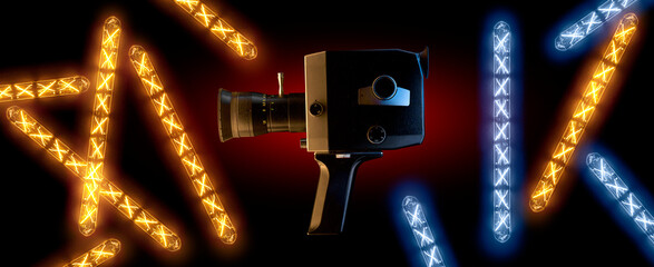 Old 8mm movie camera surrounded by warm and cold neon lights. Retro video recording equipment.
