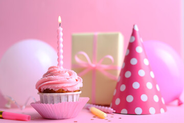 A deliciously appealing and beautifully decorated Frosted Birthday Cupcake topped with a Candle