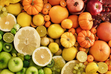 Colorful bright background of fresh ripe sweet citrus fruits: orange and tangerine, green lime and yellow lemon, grapefruit and kumquat