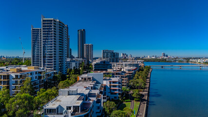 Fototapeta premium Panorama Aerial view above Rhodes with views to Meadowbank and Olympic park and Wentworth Point and Concord West with Parramatta River in Sydney NSW Australia