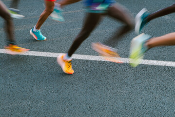 Runners' legs blurred in motion during a city marathon 