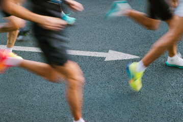 Motion blur shot of runners with arrow on the ground 