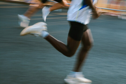 A runner blurred into motion during a city marathon 