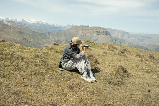 Young woman filming mountains