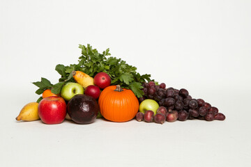 A variety of fruits and vegetables are displayed on a white background