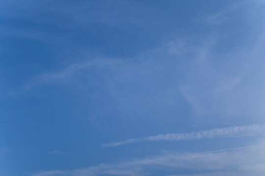 Clear blue sky with wispy clouds