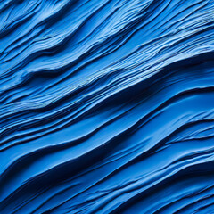 Obraz premium Abstract bold blue paint brush deep swirling flowing pattern ridges in blue paint