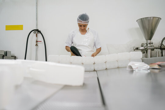 Focused female food plant worker