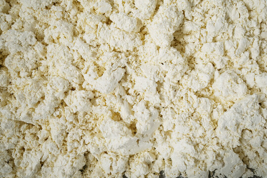Fresh homemade cheese forming a textured background