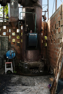 Old industrial boiler burning coal for heating water