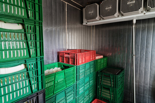Storage baskets inside an industrial refrigerator storing foodstuffs