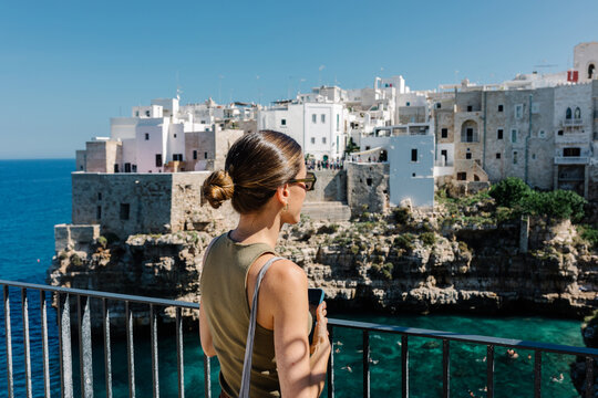 Traveler enjoying a sunny day from Polignano a Mare, Puglia, Italy