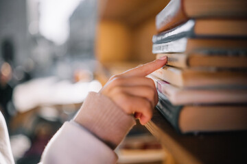 Exploring a book collection at an outdoor market during a sunny afternoon © Irina Magrelo