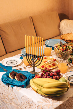 Still life of Hanukkah festive table and golden menorah.