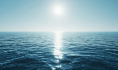 An endless expanse of calm ocean water under a clear blue sky, with the sun casting a bright reflection on the surface.