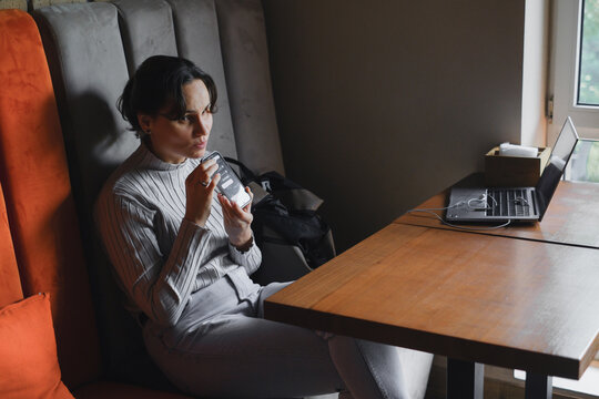 Blind woman using smartphone in modern workspace