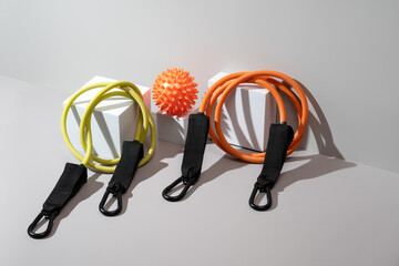 Variety of fitness equipment arranged on a light background