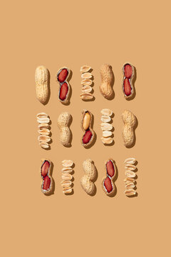 Top view of raw peanuts in various stages of peeling