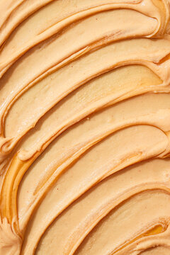 Close-up of creamy peanut butter with textured swirls