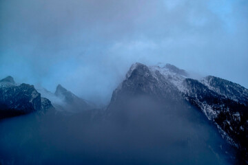 Misty peaks in twilight blue haze