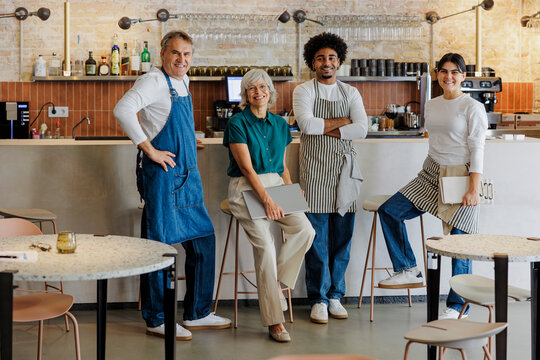 Diverse restaurant staff posing in modern bistro