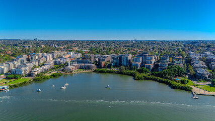 Fototapeta premium Panorama Aerial view above Rhodes with views to Meadowbank and Olympic park and Wentworth Point and Concord West with Parramatta River in Sydney NSW Australia