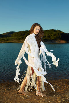 Unusually dressed woman walks by the lake