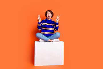 Full body length photo of brown hair woman in trendy outfit sitting white podium showing double v...