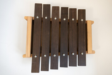 Children's Wooden Xylophone with Dark Wood Bars on a Light Background - Musical Toy for Kids