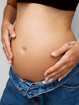 Black and White Close-Up of Pregnant Woman Holding Belly