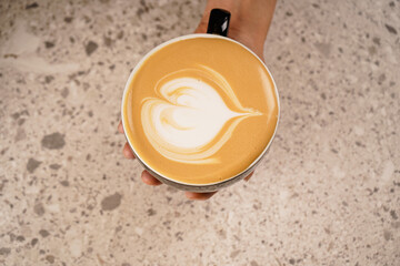Cappuccino, latte, coffee with milk in a white glass mug. Coffee foam. A heart drawn. View from above. On a white background. Isolated. Space for text. Copy space.