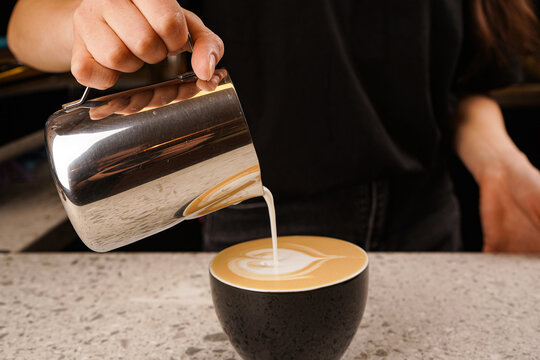Close-up of the process of brewing cappuccino coffee with thick milk foam from the cappuccinatore. - Powered by Adobe