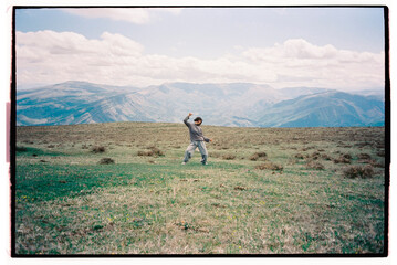 Woman dancing in front of the mountain range