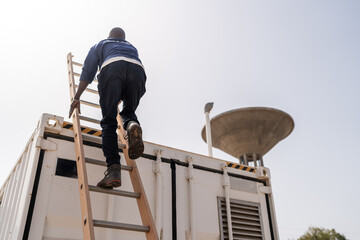 Technician climbing ladder on top of industrial water