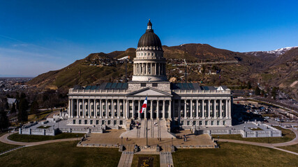 MARCH 2024, SALT LAKE CITY, UTAH - USA - State Capitol Building overlooks Salt Lake City (SLC) skyline and Wasatch Mountain range with snow