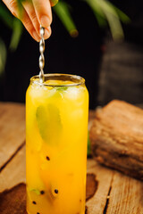 Freshly squeezed lemonade glows on a dark background, with vibrant citrus slices floating inside. Perfectly chilled, this refreshing drink is ideal for warm summer days or evening relaxation.
