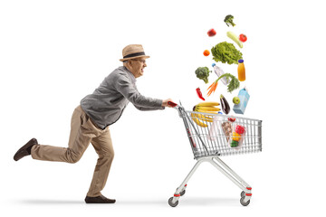 Elderly gentleman running with a shopping cart and falling groceries